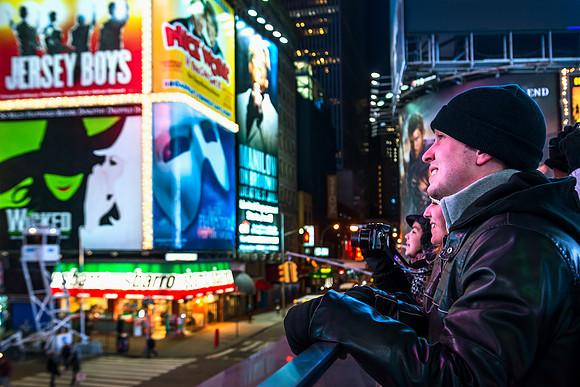 New York City - Tourists looking at Times Square Marquees